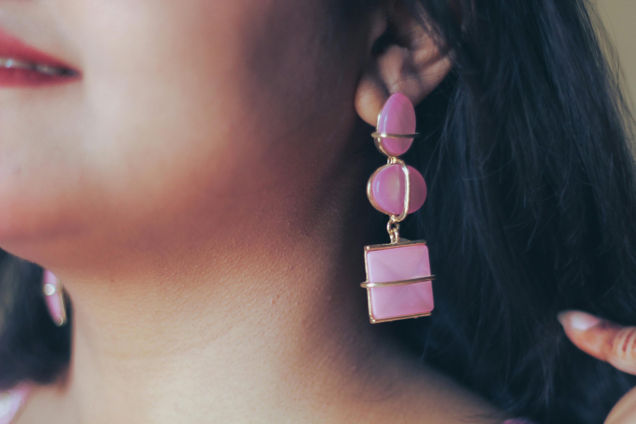 Close-up image of a woman wearing pink earrings, emphasizing style and fashion, captured in Dhaka.